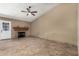 Cozy living room with tile floors, fireplace, and a ceiling fan for added comfort at 6543 E Preston St, Mesa, AZ 85215