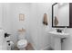 Chic powder room with a pedestal sink, modern fixtures, and neutral decor, offering a clean and stylish design at 759 E Zesta Ln # 104, Gilbert, AZ 85297