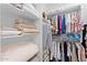 Organized walk-in closet with shelving for clothes and linens at 759 E Zesta Ln # 104, Gilbert, AZ 85297