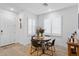 Bright dining area with a round table, plantation shutters, and modern decor, creating a welcoming space at 759 E Zesta Ln # 104, Gilbert, AZ 85297