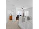 Bright hallway leading to an office space featuring white walls and a ceiling fan at 759 E Zesta Ln # 104, Gilbert, AZ 85297