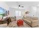 Comfortable living room featuring a leather sofa, shutters, and a modern ceiling fan at 759 E Zesta Ln # 104, Gilbert, AZ 85297