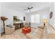 Bright living room with a comfortable sofa, an armchair, an area rug, and a ceiling fan at 759 E Zesta Ln # 104, Gilbert, AZ 85297