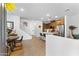 Open-concept living space with modern wood flooring, a staircase, and a view into the kitchen at 759 E Zesta Ln # 104, Gilbert, AZ 85297