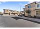 Street view of two-story townhomes featuring attached garages, desert landscaping, and stucco exteriors at 759 E Zesta Ln # 104, Gilbert, AZ 85297