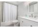 Clean bathroom with a shower-tub combo with white shower curtain, toilet, and sink with storage at 7830 E Camelback Rd # 108, Scottsdale, AZ 85251