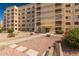 Well-maintained condo building featuring balconies and a landscaped entrance with desert landscaping at 7830 E Camelback Rd # 108, Scottsdale, AZ 85251