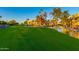 Scenic view of the golf course and pond with lush green fairways and mature trees in a residential area at 7830 E Camelback Rd # 108, Scottsdale, AZ 85251