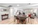 Bright living room featuring a dining area, light wood floors, and sliding glass doors to a private balcony at 7830 E Camelback Rd # 108, Scottsdale, AZ 85251