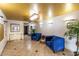 Grand lobby with elegant gold ceiling, chandelier, blue seating, and lush greenery at 7830 E Camelback Rd # 108, Scottsdale, AZ 85251