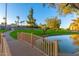 Charming pond view with a small bridge, lush greenery, and mature trees creating a tranquil ambiance at 7830 E Camelback Rd # 108, Scottsdale, AZ 85251