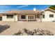 The backyard features a covered patio, low-maintenance gravel, and well-maintained landscaping at 817 E Meadow Ln, Phoenix, AZ 85022