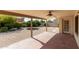 Covered patio and low maintenance gravel backyard with a ceiling fan, perfect for outdoor living at 817 E Meadow Ln, Phoenix, AZ 85022