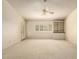 Bright bedroom featuring neutral carpet, built-in shelving, and a door to outdoor space at 817 E Meadow Ln, Phoenix, AZ 85022