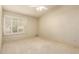 A carpeted bedroom with white walls features window shutters to allow for natural light and privacy at 817 E Meadow Ln, Phoenix, AZ 85022