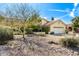 Single-story home featuring desert landscaping, a two-car garage, and a red tile roof on a sunny day at 817 E Meadow Ln, Phoenix, AZ 85022