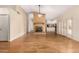 Open-concept living room with hardwood floors, a brick fireplace, a ceiling fan, and French doors at 817 E Meadow Ln, Phoenix, AZ 85022