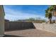 Backyard with a rock ground cover, block wall, mountain views, and two palm trees at 821 S Parker Pl, Casa Grande, AZ 85122