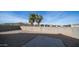 Backyard featuring a gravel ground cover, block walls, a patio, and palm tree views at 821 S Parker Pl, Casa Grande, AZ 85122