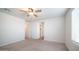 Neutral-toned bedroom with a ceiling fan, plush carpeting, and a well-lit atmosphere at 821 S Parker Pl, Casa Grande, AZ 85122