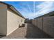 A narrow, gravel-landscaped side yard is enclosed by a block wall; an AC unit is visible at 821 S Parker Pl, Casa Grande, AZ 85122