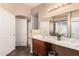 Bathroom showcasing a vanity with a sink and large mirror, complemented by warm lighting at 8305 W Pioneer St, Tolleson, AZ 85353