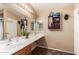 Bright bathroom featuring a double sink vanity with a large mirror and modern fixtures at 8305 W Pioneer St, Tolleson, AZ 85353