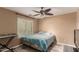 Cozy bedroom with a ceiling fan, window, and a comfortable bed with blue bedding at 8305 W Pioneer St, Tolleson, AZ 85353