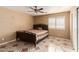 Inviting bedroom features a ceiling fan and a window that lets in natural light at 8305 W Pioneer St, Tolleson, AZ 85353