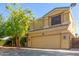 Two-story stucco home with a two-car garage and mature landscaping, offering curb appeal at 8305 W Pioneer St, Tolleson, AZ 85353