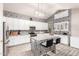 Modern kitchen featuring white cabinets, stylish backsplash, and a functional island with seating at 8305 W Pioneer St, Tolleson, AZ 85353