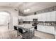 Beautiful kitchen with modern appliances, white cabinetry, and a unique backsplash design at 8305 W Pioneer St, Tolleson, AZ 85353