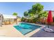 Inviting backyard pool with ample seating and lush landscaping at 8305 W Pioneer St, Tolleson, AZ 85353