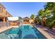 Inviting backyard pool with a gazebo and lush landscaping, perfect for relaxation at 8305 W Pioneer St, Tolleson, AZ 85353