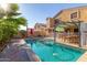 Backyard swimming pool with patio seating and lush landscaping at 8305 W Pioneer St, Tolleson, AZ 85353