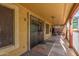 Covered porch featuring Saltillo tile, ceiling fans, and black security door at 8305 W Pioneer St, Tolleson, AZ 85353