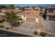 Aerial view of a home with a large driveway, a well-maintained roof, and mature trees, great curb appeal at 856 E Indian Wells Pl, Chandler, AZ 85249