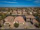 An aerial view of a community with waterfront homes, red tile roofs, and lush landscaping on a sunny day at 856 E Indian Wells Pl, Chandler, AZ 85249