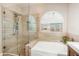 Bathroom showcasing an oversized shower with glass door and a soaking tub under a window at 856 E Indian Wells Pl, Chandler, AZ 85249