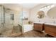 Bright bathroom featuring double sinks, a shower with glass door, and a soaking tub at 856 E Indian Wells Pl, Chandler, AZ 85249