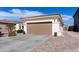 Spacious home featuring a wide driveway leading to a two-car garage, complemented by tidy landscaping at 856 E Indian Wells Pl, Chandler, AZ 85249