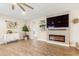 Bright living room featuring luxury vinyl floors, built-in shelving and updated fireplace at 856 E Indian Wells Pl, Chandler, AZ 85249