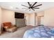 Well-lit main bedroom showcasing a stylish chair, dresser, and fan at 856 E Indian Wells Pl, Chandler, AZ 85249