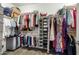 Organized walk-in closet featuring built-in shelving and ample storage for clothes at 856 E Indian Wells Pl, Chandler, AZ 85249