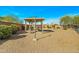 Private backyard features gravel landscaping, a covered patio area, and secure fencing at 9151 W Greenway Rd # 258, Peoria, AZ 85381