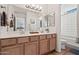 Bright bathroom features a double sink vanity with modern faucets, and a separate toilet and shower area at 9151 W Greenway Rd # 258, Peoria, AZ 85381