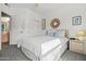 Cozy bedroom features neutral walls, carpeted floor, and white bedding; bathroom is visible through doorway at 9151 W Greenway Rd # 258, Peoria, AZ 85381