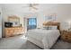 Bright bedroom featuring neutral carpet, a sliding glass door to balcony, and light wood furnishings at 9151 W Greenway Rd # 258, Peoria, AZ 85381