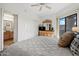 Bedroom with neutral carpet, a dresser with TV, and sliding glass doors to balcony at 9151 W Greenway Rd # 258, Peoria, AZ 85381