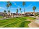 Beautiful condo community featuring lush green landscaping, mature palm trees, and well-maintained buildings at 9151 W Greenway Rd # 258, Peoria, AZ 85381